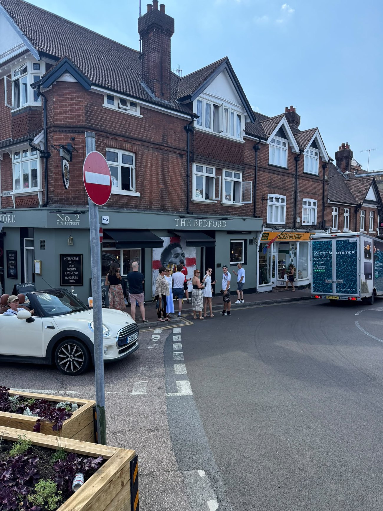 Crowd viewing the England mural outside The Bedford